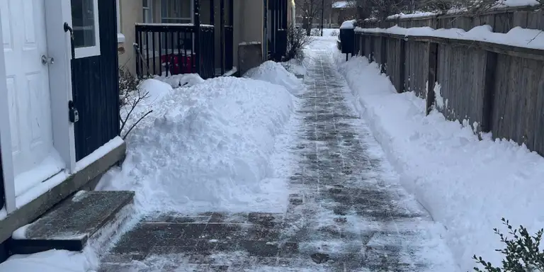 Snow being professionally removed from a rooftop
