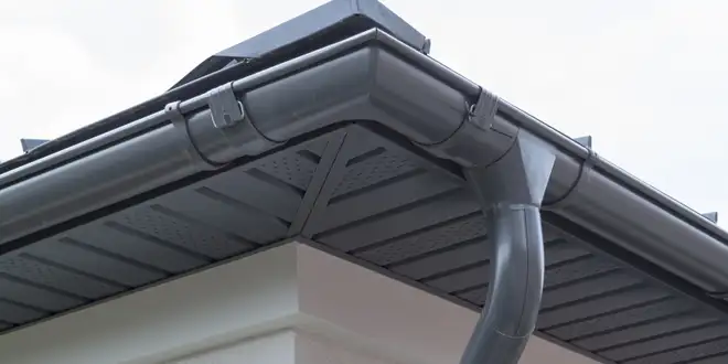 Downspout extension carrying rainwater away from a home's foundation