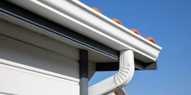Close-up of a gutter section being resecured to the fascia