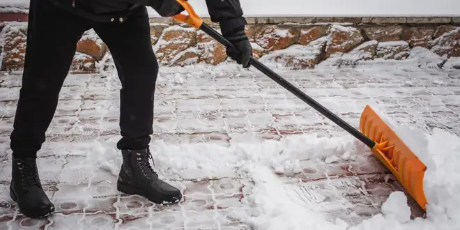 Snow-covered walkway cleared during winter service