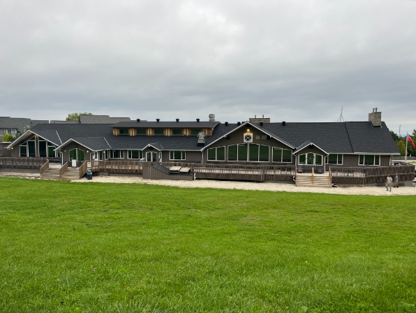 Large building with a new black shingle roof installed by Weldon Roofing